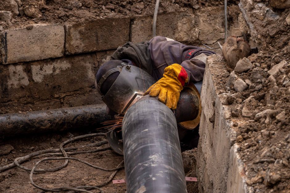 Close-up of a drainage pipe repair with equipment in a suburban London street