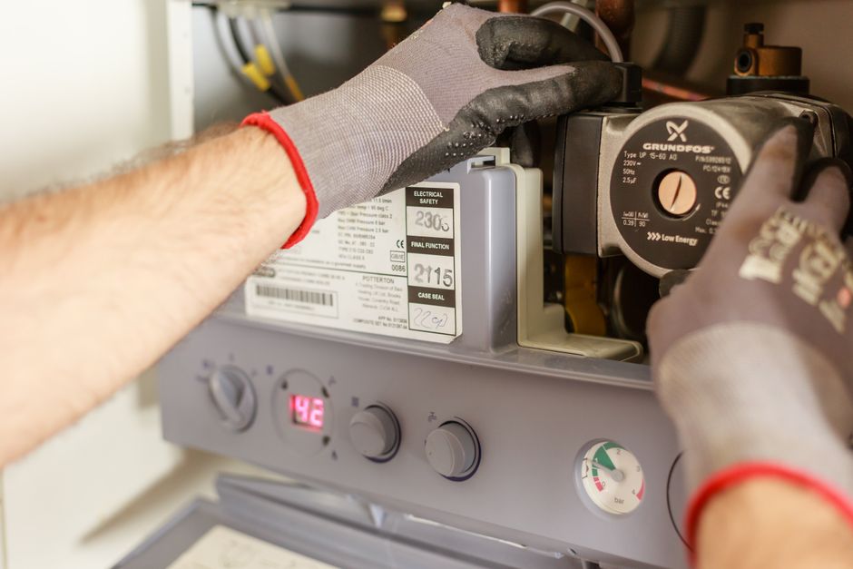 Close-up of a homeowner attempting to unblock a kitchen sink drain with a plunger